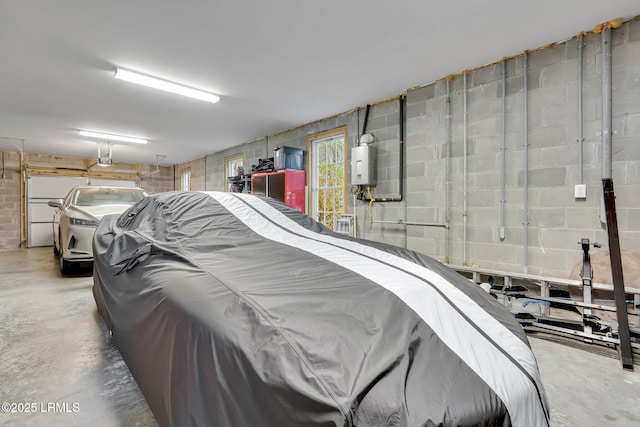 garage with a garage door opener and water heater