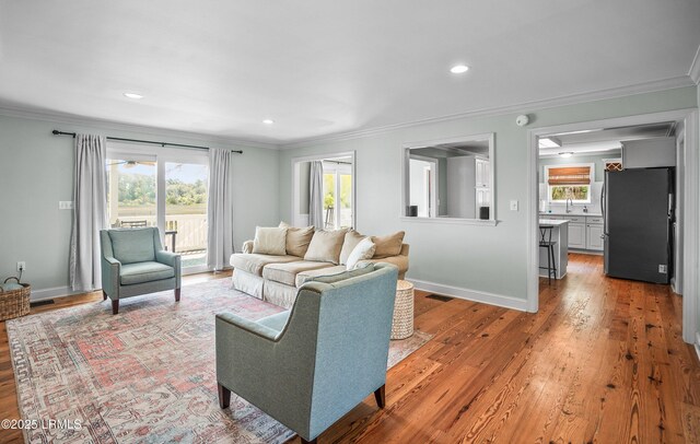 79 Lost Island Rd, Beaufort, SC 29907 - living room with crown molding, visible vents, baseboards, and wood finished floors