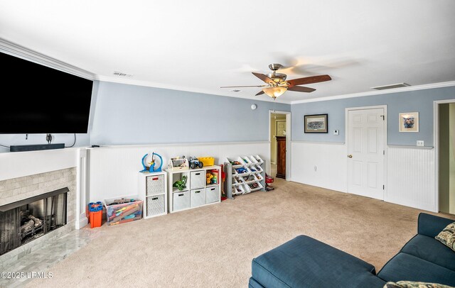 79 Lost Island Rd, Beaufort, SC 29907 - carpeted living area with ornamental molding, a ceiling fan, visible vents, and a wainscoted wall