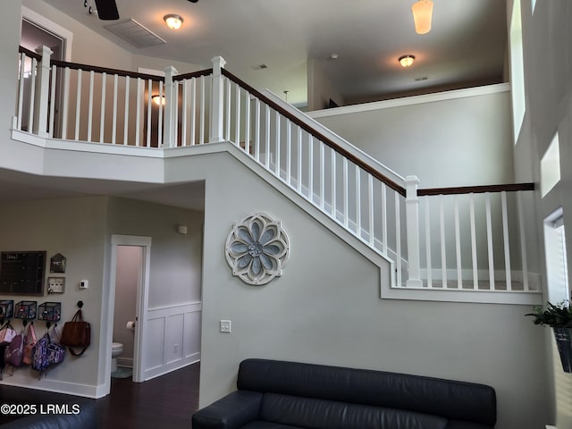 125 Pleasant Point Dr, Beaufort, SC 29907 - staircase featuring wood finished floors and wainscoting