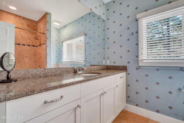 full bathroom with wallpapered walls, baseboards, a shower, tile patterned flooring, and vanity