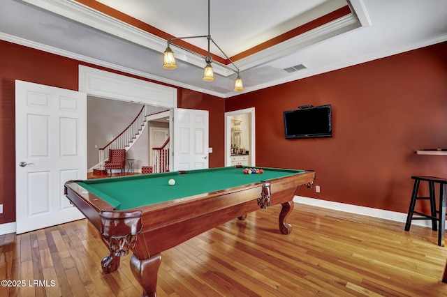 game room featuring billiards, visible vents, hardwood / wood-style floors, a tray ceiling, and crown molding