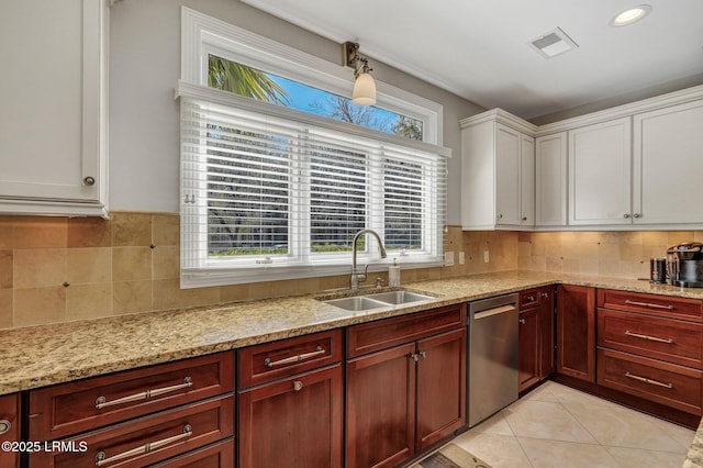 kitchen featuring light tile patterned floors, tasteful backsplash, visible vents, stainless steel dishwasher, and a sink