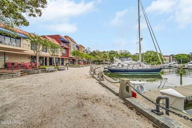 surrounding community featuring a water view and a boat dock