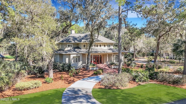 view of front of property featuring a front yard and a chimney