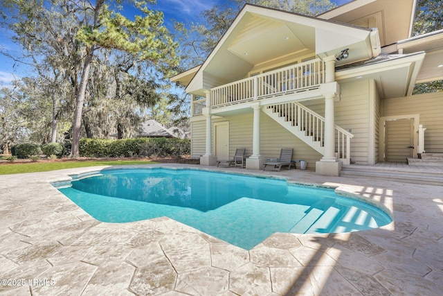 view of swimming pool featuring stairs, a patio, and a fenced in pool