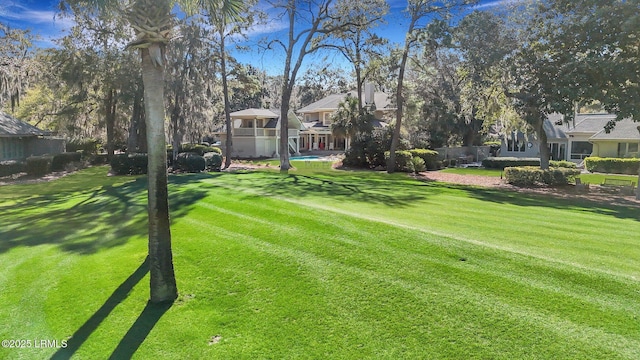 view of yard featuring an outdoor pool