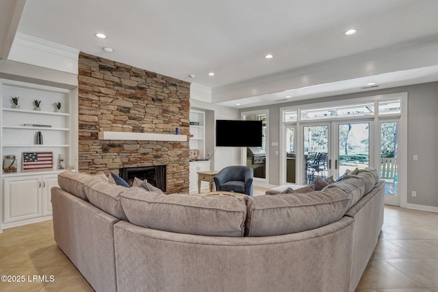 living area featuring built in shelves, french doors, light tile patterned floors, recessed lighting, and a stone fireplace