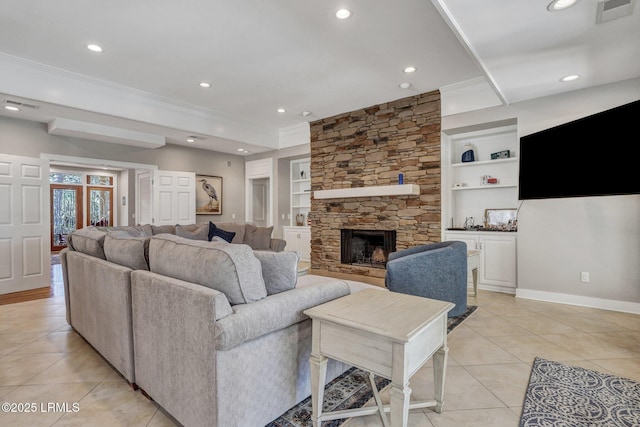 living area with built in shelves, light tile patterned floors, visible vents, ornamental molding, and baseboards