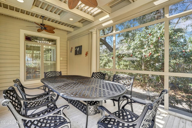 sunroom / solarium with beam ceiling and ceiling fan