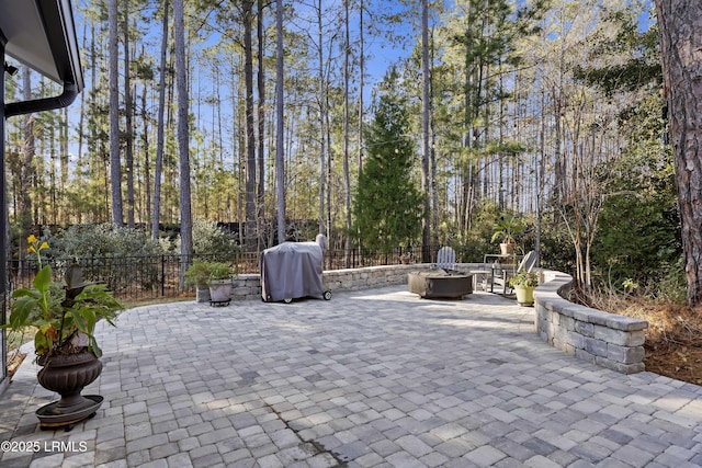 view of patio with area for grilling and an outdoor fire pit