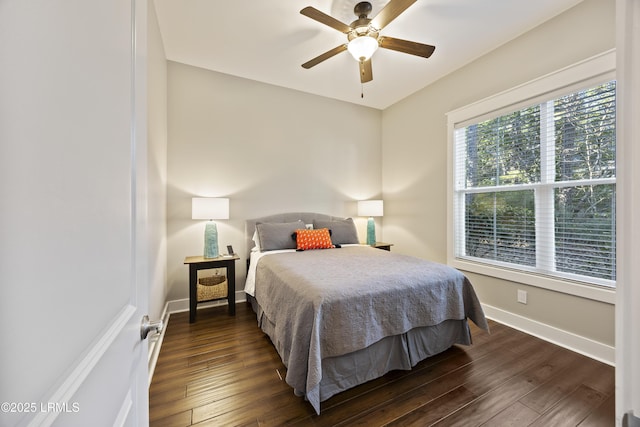 bedroom with dark wood-type flooring and ceiling fan