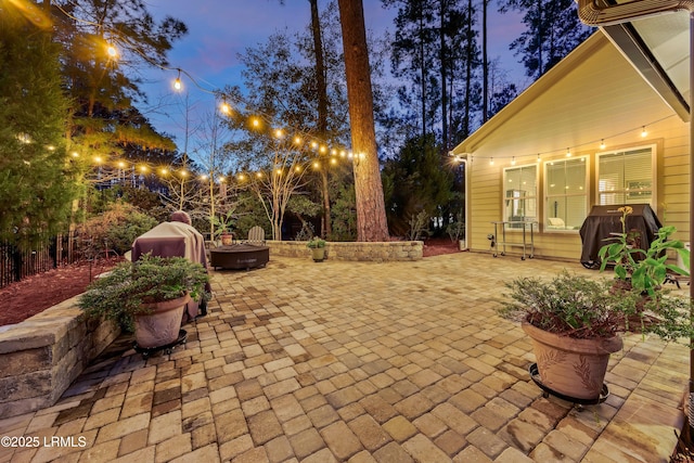 view of patio / terrace with an outdoor fire pit and a grill