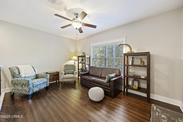 living room featuring dark wood-type flooring and ceiling fan