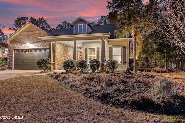 view of front of house featuring a garage, stone siding, and concrete driveway