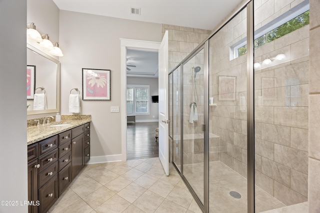 bathroom featuring vanity, tile patterned flooring, and a shower with door