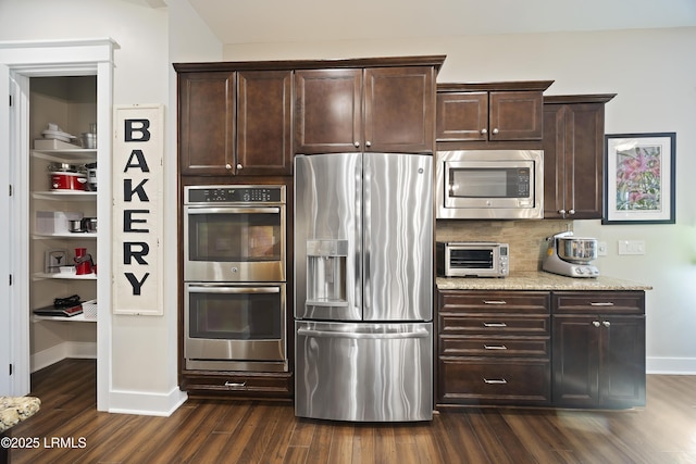 kitchen with dark wood-type flooring, dark brown cabinets, and stainless steel appliances