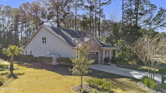 view of side of home with cooling unit and a garage