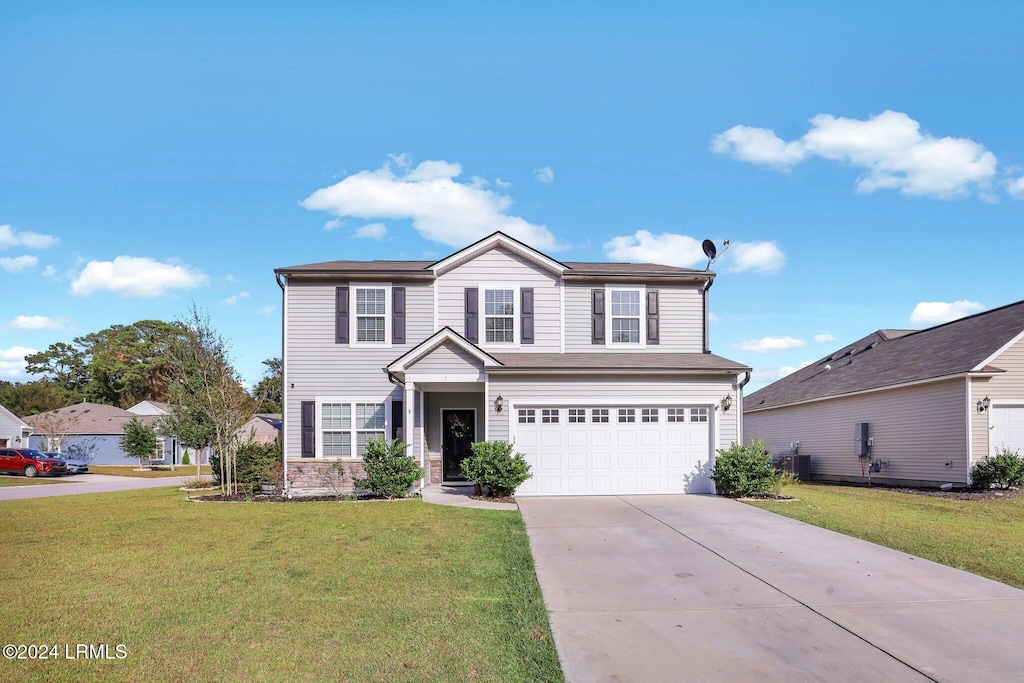 view of property with a garage, central AC, and a front lawn