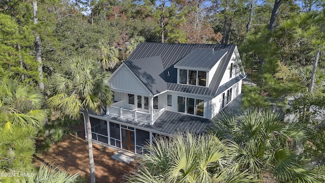 back of house featuring a balcony and a sunroom