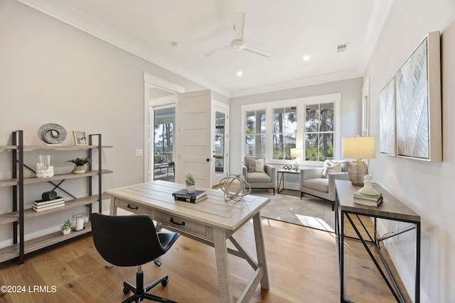 office space featuring ceiling fan, ornamental molding, and light hardwood / wood-style flooring