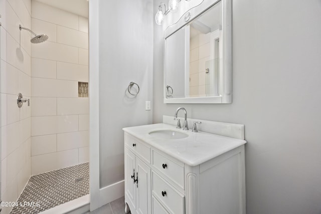 bathroom featuring vanity and a tile shower