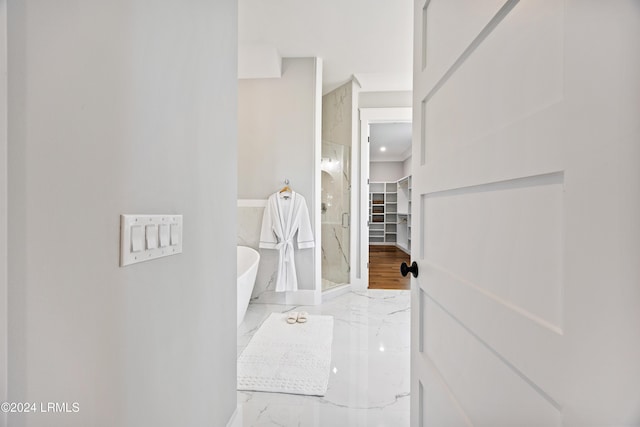 bathroom featuring separate shower and tub