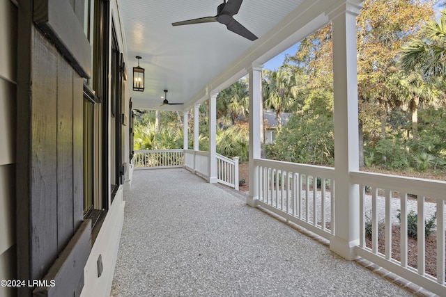 unfurnished sunroom featuring ceiling fan