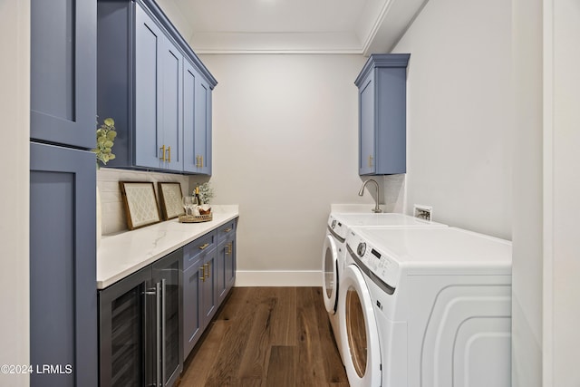 laundry area with crown molding, dark hardwood / wood-style floors, cabinets, wine cooler, and separate washer and dryer