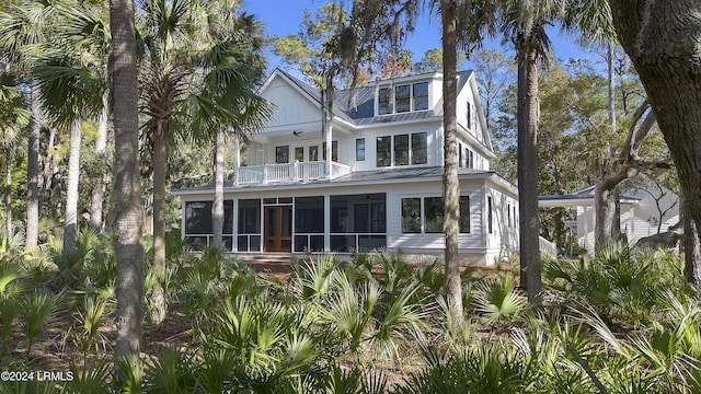 coastal home featuring a sunroom and a balcony