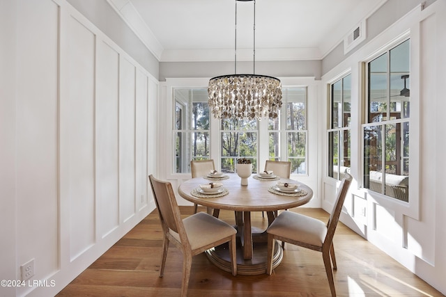 sunroom / solarium with an inviting chandelier