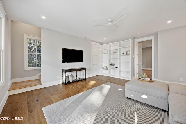 living room with hardwood / wood-style flooring and ceiling fan