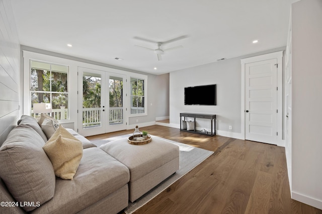 living room with hardwood / wood-style floors, french doors, and ceiling fan