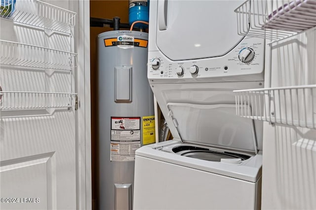 laundry room featuring electric water heater and stacked washing maching and dryer