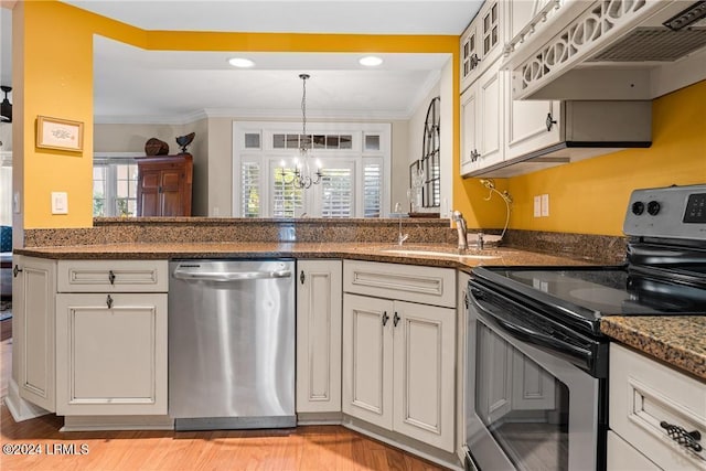 kitchen featuring premium range hood, white cabinetry, crown molding, appliances with stainless steel finishes, and dark stone counters