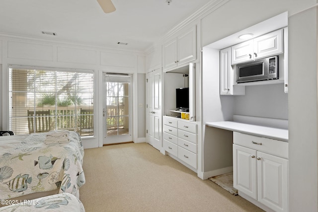 carpeted bedroom featuring access to exterior, ornamental molding, and ceiling fan