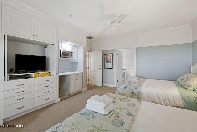 bedroom with crown molding, connected bathroom, light colored carpet, and ceiling fan