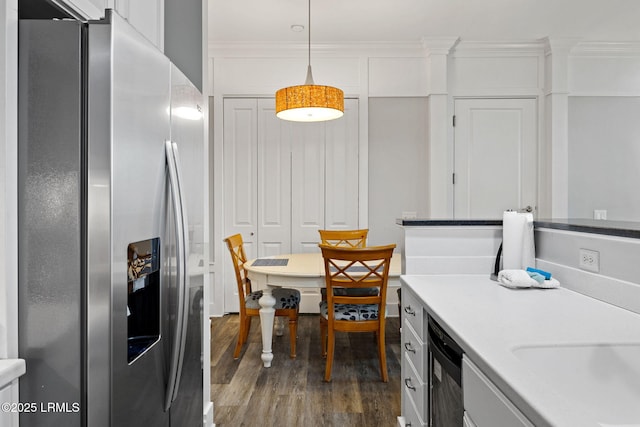 kitchen featuring white cabinetry, crown molding, stainless steel fridge with ice dispenser, dark hardwood / wood-style flooring, and pendant lighting