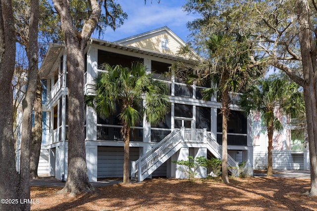 rear view of property featuring a sunroom