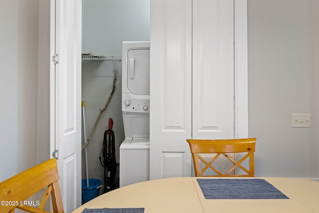 laundry room with stacked washing maching and dryer