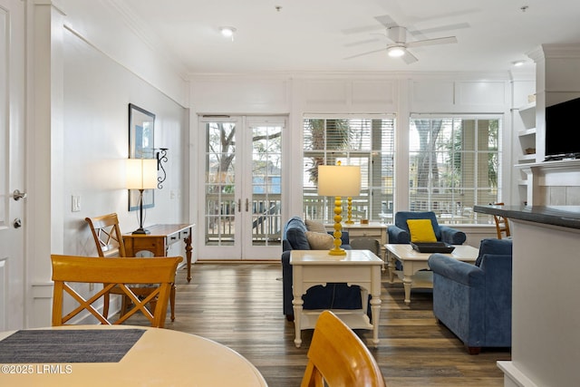 living room featuring a healthy amount of sunlight, ornamental molding, and dark hardwood / wood-style floors