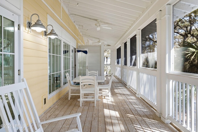 sunroom / solarium with ceiling fan and lofted ceiling