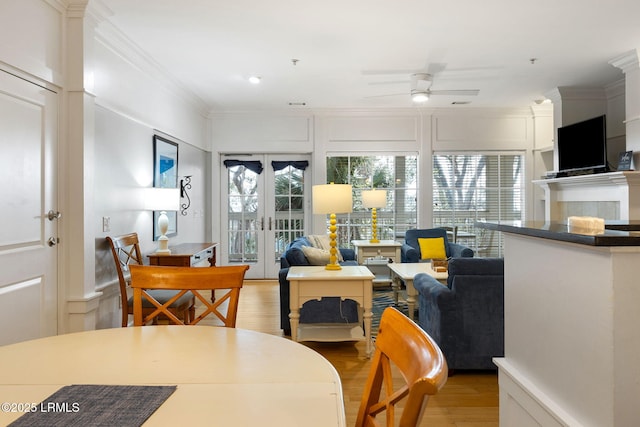 dining room featuring french doors, ceiling fan, crown molding, and light hardwood / wood-style floors