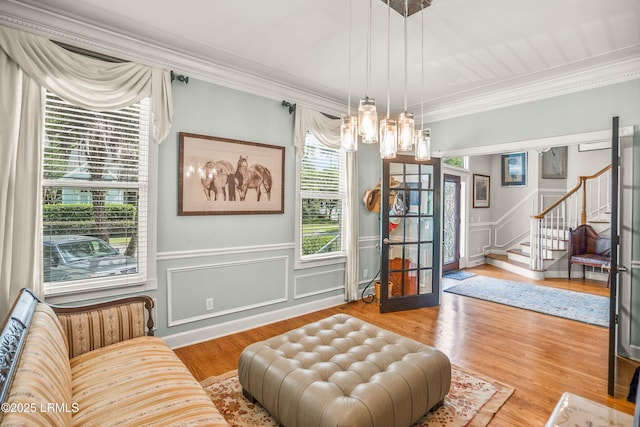 5 Petigru Dr, Beaufort, SC 29902 - sitting room with stairway, a chandelier, crown molding, wood finished floors, and a wainscoted wall