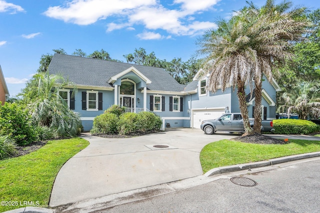 5 Petigru Dr, Beaufort, SC 29902 - view of front of property featuring stucco siding, concrete driveway, a garage, a shingled roof, and a front yard