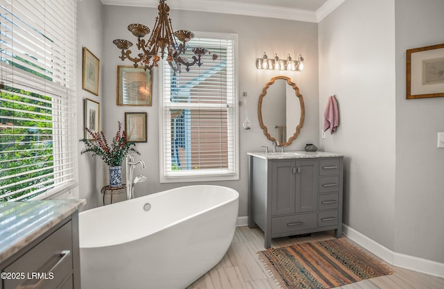 5 Petigru Dr, Beaufort, SC 29902 - full bathroom with a chandelier, a freestanding tub, vanity, and ornamental molding
