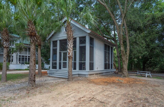 5 Petigru Dr, Beaufort, SC 29902 - view of home's exterior featuring a sunroom and stucco siding