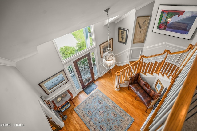 5 Petigru Dr, Beaufort, SC 29902 - foyer featuring lofted ceiling, stairway, ornamental molding, a chandelier, and wood finished floors