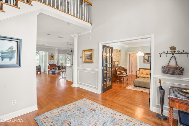 5 Petigru Dr, Beaufort, SC 29902 - entryway with crown molding, wood finished floors, and a wainscoted wall