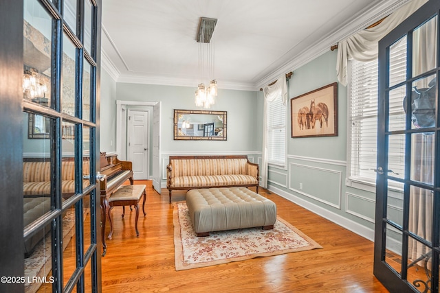 5 Petigru Dr, Beaufort, SC 29902 - sitting room with a chandelier, crown molding, wood finished floors, and a wainscoted wall